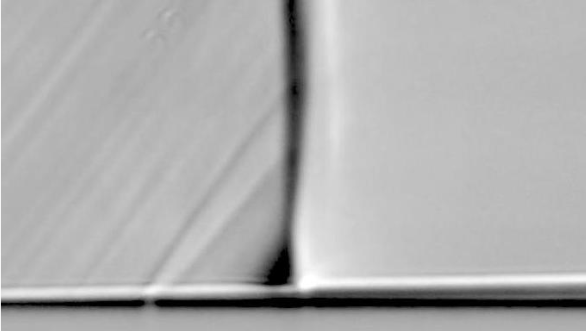 Schlieren images of normal shock wave turbulent boundary layer interactions attached at M_\infty = 1.28 , Re_{x_{shock}} = 1.79 × 10^6